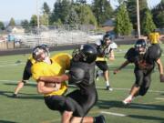 Joe Harris (right) brings down the ball-handler during practice Friday, at Fishback Stadium.