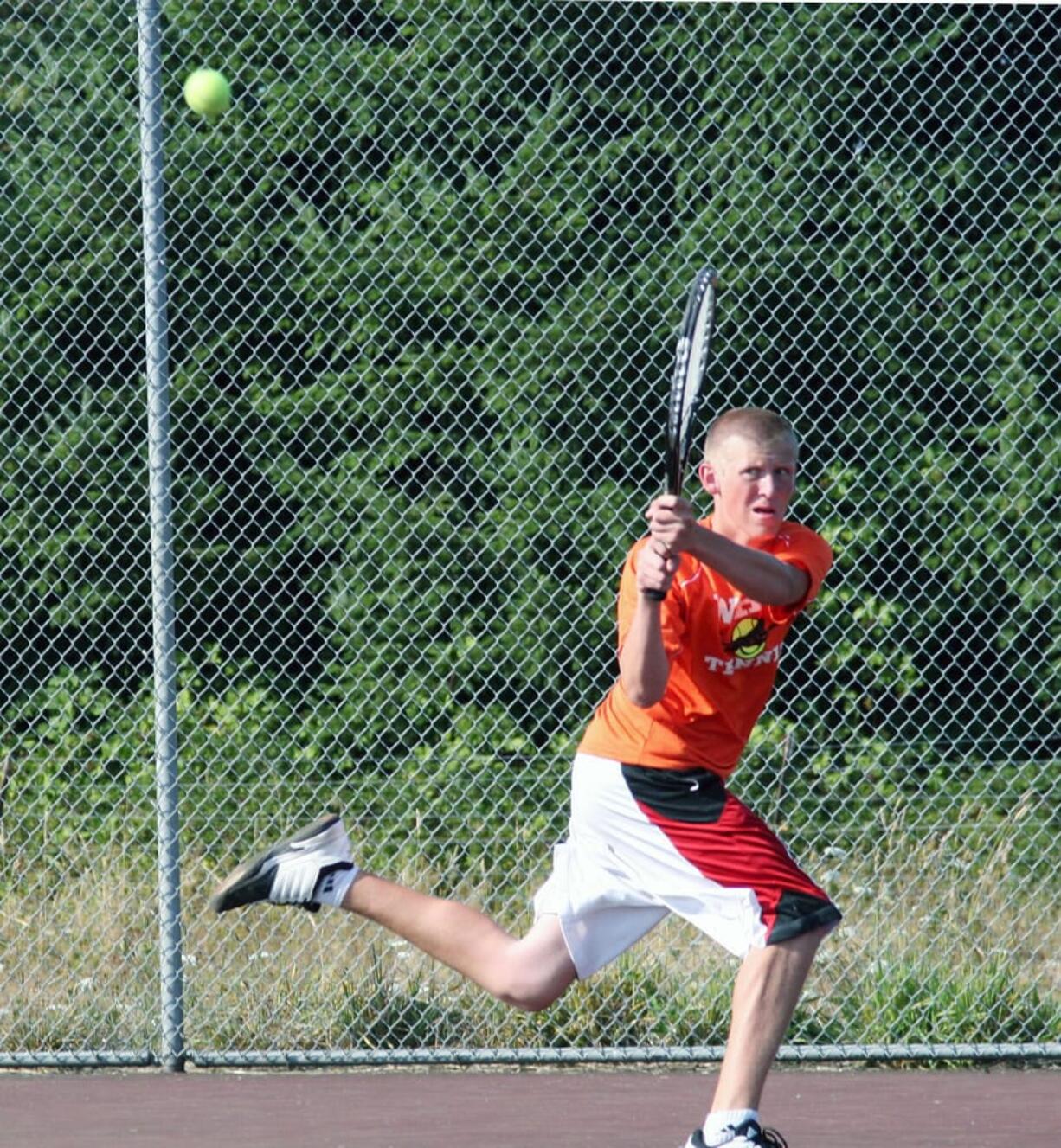 Regan Townsend backhands the ball for Washougal Friday, on the Camas tennis court.