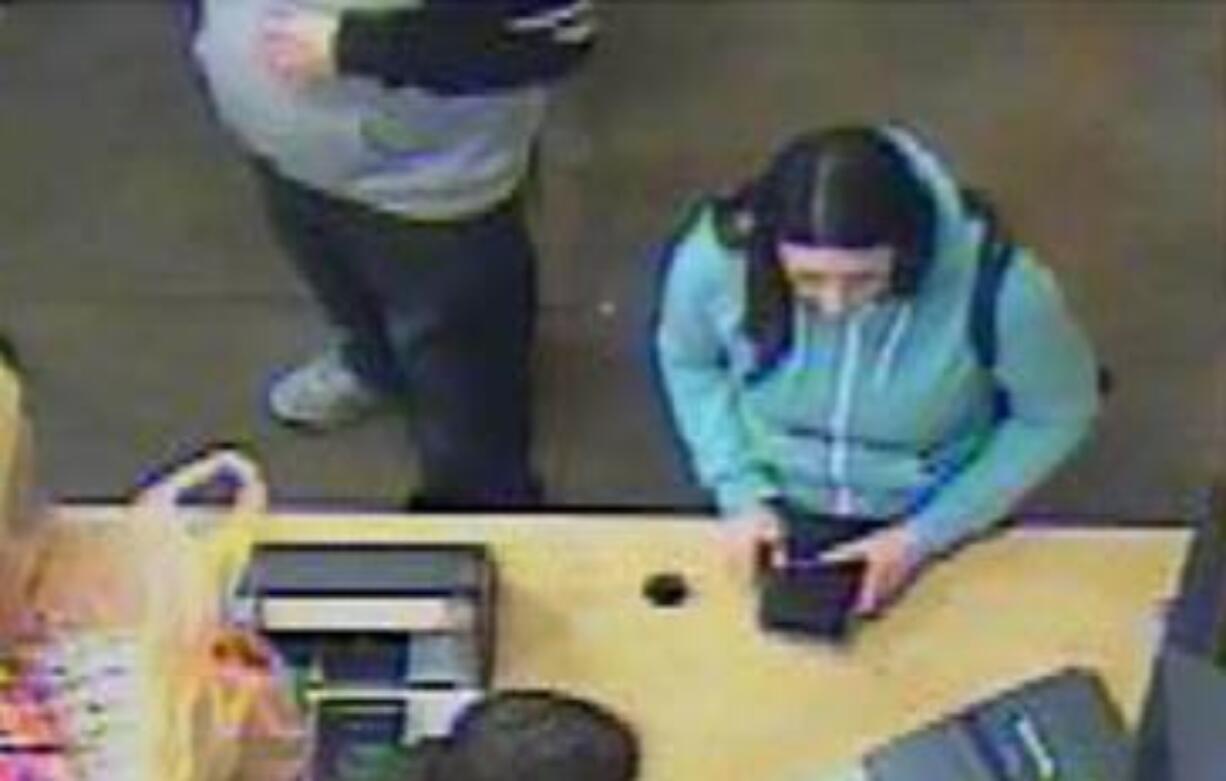 The Battle Ground Police Department is asking for the public's help in identifying a man and woman, seen here, thought to have been used fraudulent checks to make purchases around the county.