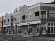 A pedestrian walks past buildings Felida Village, the new development project which includes a mix of commercial and residential space at the corner of Northwest 119th Street and 36th Avenue. Developer Ron Edwards, who lives five blocks from the new buildings, said he hopes the project becomes a gathering place for the community.