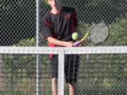 Gus Cooper lobs the tennis ball over the net for Camas Wednesday.