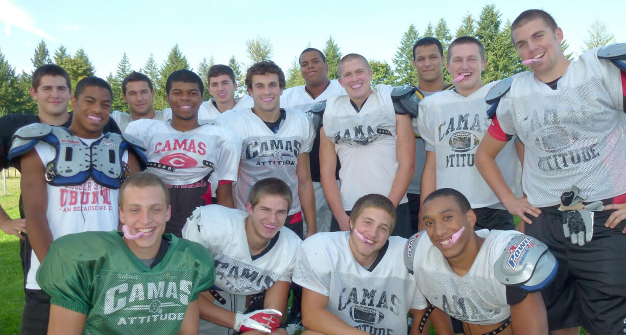 Camas High School football players show of their pink mouthguards, which were designed by Franson Family Dentistry of downtown Camas.