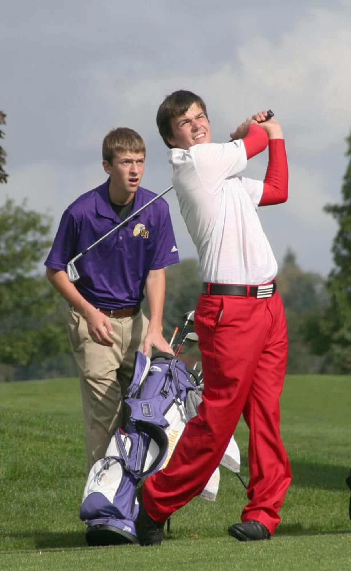 Daniel Patterson watches his tee shot land on the green during the 3A district tournament Wednesday, at the Tri-Mountain golf course in Ridgefield.