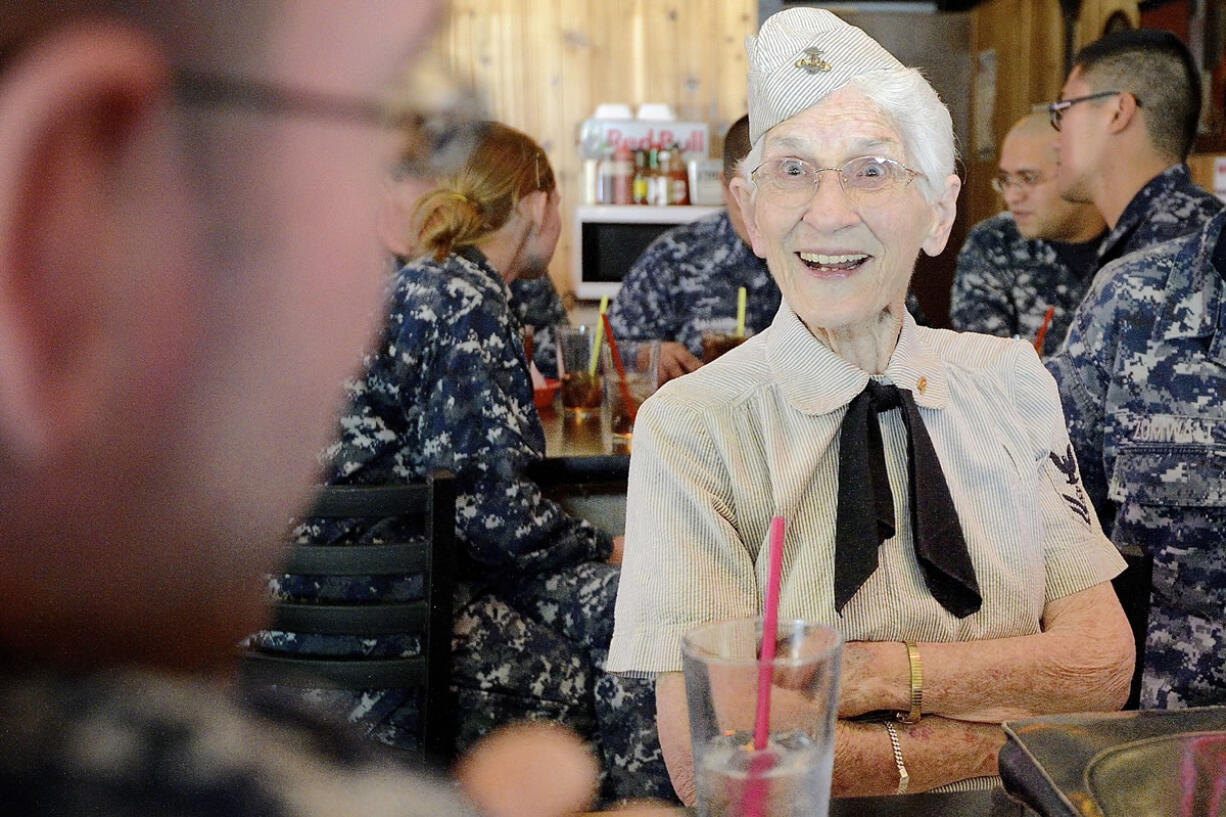 Evelyn Argo, 90, shares stories of life in the Navy with sailor Dan Vogel, left, on Monday. Argo was a Navy aviation gunnery instructor during World War II.