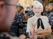 Evelyn Argo, 90, shares stories of life in the Navy with sailor Dan Vogel, left, on Monday. Argo was a Navy aviation gunnery instructor during World War II.