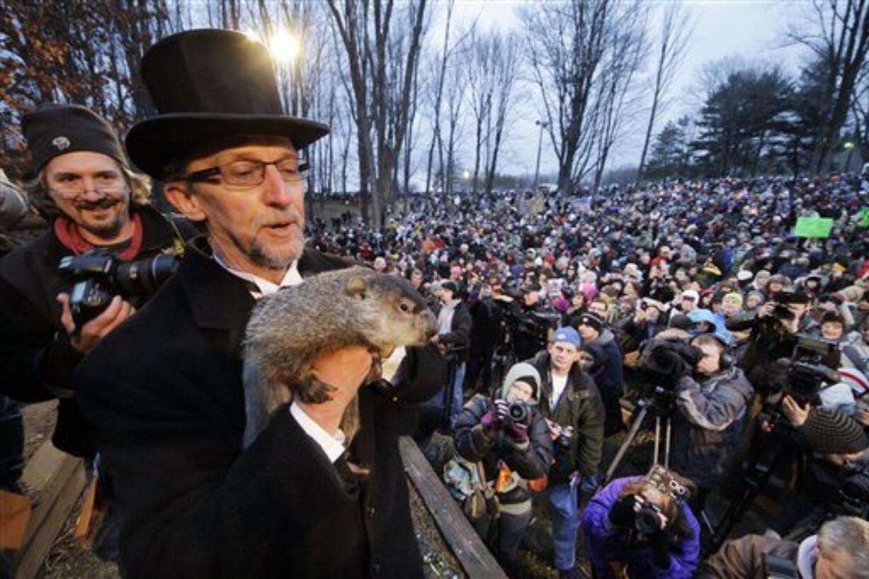 Groundhog Club handler Ron Ploucha holds Punxsutawney Phil, the weather prognosticating groundhog, during the 126th celebration of Groundhog Day on Gobbler's Knob in Punxsutawney, Pa. Thursday, Feb. 2, 2012. Phil saw his shadow, forecasting six more weeks of winter weather. (AP Photo/Gene J.