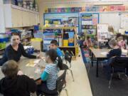 Orchards Elementary School kindergarten teacher Brenda Parker goes over a reading lesson with her students on Wednesday.