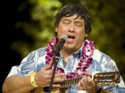 Francis Doo sings traditional Hawaiian music before dinner Saturday at the Ke Kukui Foundation Cultural Lu'au at Thomas Jefferson Middle School.