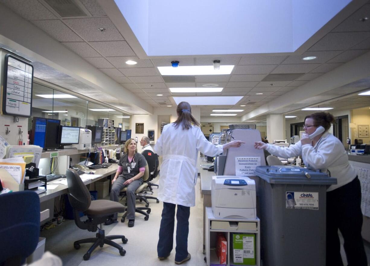 A nursing station at PeaceHealth Southwest's emergency department bustles with activity.