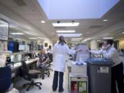 A nursing station at PeaceHealth Southwest's emergency department bustles with activity.