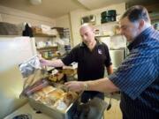 Steven Lane/The Columbian files Rich Melnick, left, and Chuck Chronis are hosting another free Thanksgiving meal at Chronis' restaurant on Thursday.