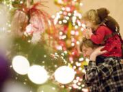 Steven Lane/Columbian files Kira Louvier and her father, Jared Louvier, attend the 2008 Festival of Trees.