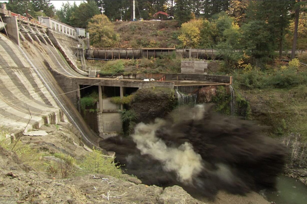 A remote video camera captures the force of a massive explosion as it breaches Condit Dam shortly after noon Oct.