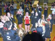 The Camas High School volleyball players celebrate winning the bi-district championship Saturday.