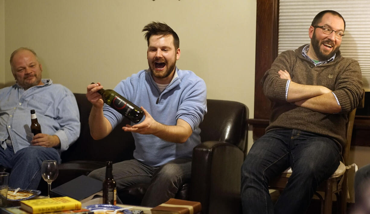 A group known as Bible and Brew, which includes James Hamilton, from left, Tanner Hall and Nicholas Tangen, gathers for drinks and discussion in Minneapolis.