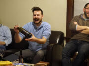 A group known as Bible and Brew, which includes James Hamilton, from left, Tanner Hall and Nicholas Tangen, gathers for drinks and discussion in Minneapolis.