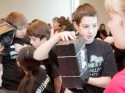 Students from Grass Valley Elementary School in Camas took part in the Nov. 19 Elementary Science Olympiad Invitational Tournament at Clark College. Pictured above are Grass Valley students (left to right) Luke Brewer, Zach Macia and Danilo Kamenko.