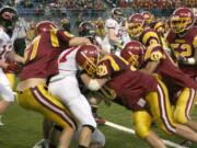 O'Dea puts the squeeze on Camas running back Nate Beasley Friday, at the Tacoma Dome.