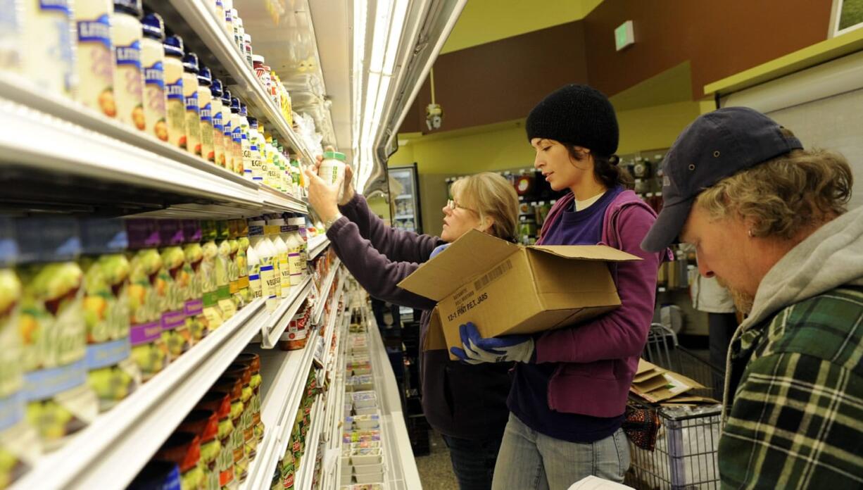 Employees stock shelves in preparation for the grand opening of the Vancouver New Seasons store  in November.