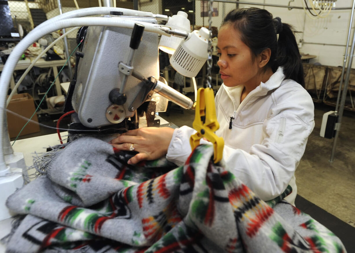 Columbian files 
 Karen Martinez works at a fringing machine at the Pendleton Woolen Mills in Washougal.