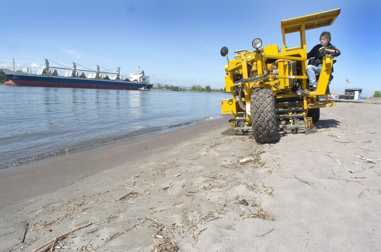 Carolleen Carroll drives a Cherrington Sand Sweeper on the beach at Frenchman&#039;s Bar after a sewage overflow in 2004 fouled the beach. Such events are less frequent now, but one occurred in December.