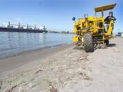 Carolleen Carroll drives a Cherrington Sand Sweeper on the beach at Frenchman&#039;s Bar after a sewage overflow in 2004 fouled the beach. Such events are less frequent now, but one occurred in December.