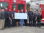 Georgia-Pacific officials presented a check for $10,000 to the Camas Fire Department.