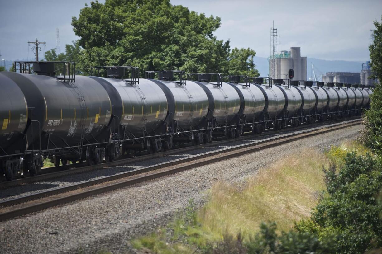 An oil train passes the Vancouver Land Bridge in June 2014.