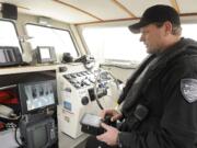 Deputy Todd Baker shows how an infrared imaging system works in the cabin of the refurbished Marine Patrol boat William Ryan.