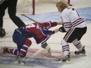 The Portland Winterhawks' Joseph Morrow, right, and the Edmonton Oil Kings' Keegan Lowe drop the gloves in the first period of game 3 in the WHL Finals at the Rose Garden on Sunday.