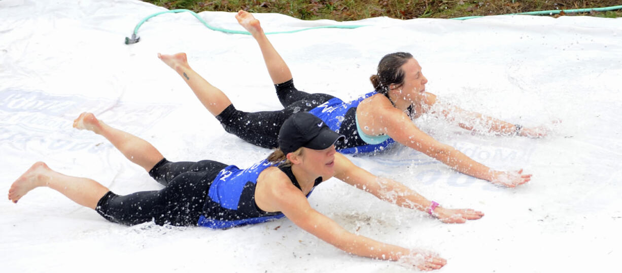 Gail Moebius and Laura Bocho, top, try the Polar Bear Slide at the Resolution Run in Battle Ground on Jan. 4, 2015.