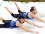 Gail Moebius and Laura Bocho, top, try the Polar Bear Slide at the Resolution Run in Battle Ground on Jan. 4, 2015.