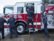 Firefighters at District 6 ritually wash a new fire engine in Hazel Dell on Thursday, just before placing it into service for the first time.