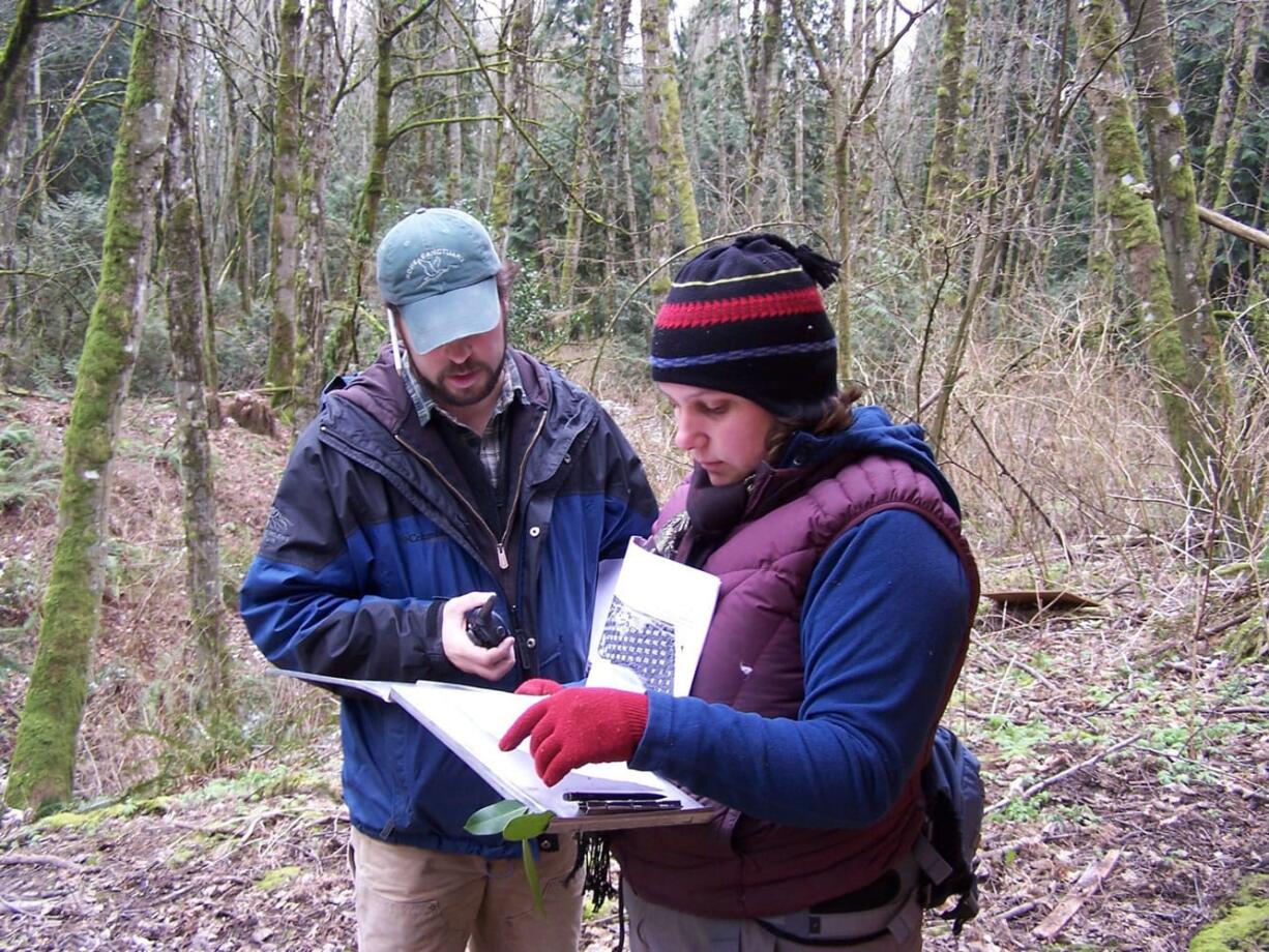 Old Evergreen Highway:  Volunteer leaders Ray Yurkewycz and Mariah Acton work on an invasive species survey at Columbia Springs Environmental Education Center in February.