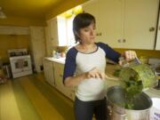 Nicole Evans of Portland purees ingredients for White Bean and Green Chili Chicken Soup at her home Wednesday.