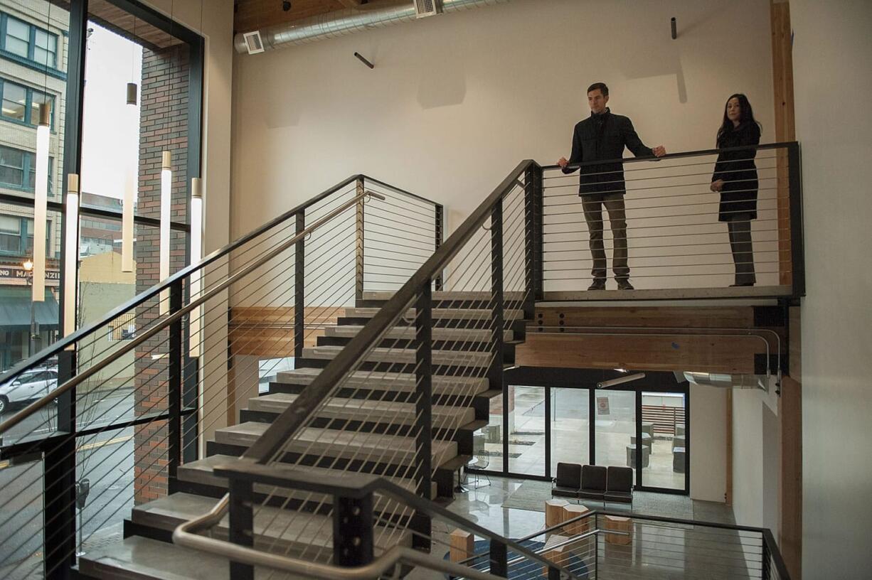 Adam Tyler, left, and Lorraine Doyle of local developer Killian Pacific take in the view from the second floor at the nearly finished Hudson Building in downtown Vancouver. The brick-and-timber structure set to open in March is the first new office building downtown in recent memory, and it will be the new home of Killian, regional engineering firm Mackenzie and a Pacific Continental Bank branch, among others.