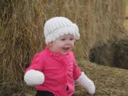 Olivia Rose Fanning plays at a pumpkin patch in October.