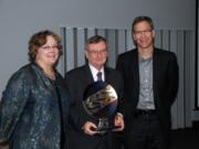 Evergreen: Evergreen Public School Superintendent John Deeder, center, received an award from Lisa Nisenfeld, left, of the Columbia River Economic Development Council and Greg Kulander from nConnect for his educational leadership in Clark County.