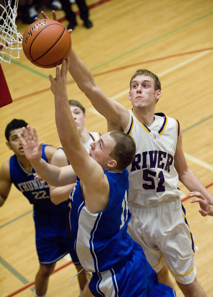 Columbia River's Isaiah Smith blocks the shot of Mountain View's Ryan Johnson during Friday's 3A district title game.