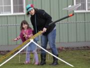 Vivian Larson, 4, and Danielle Galipeau (mom) of Portland launch a glider at the Pearson Field Education Center. The center hosted a day of flight simulation and model-glider building for kids.