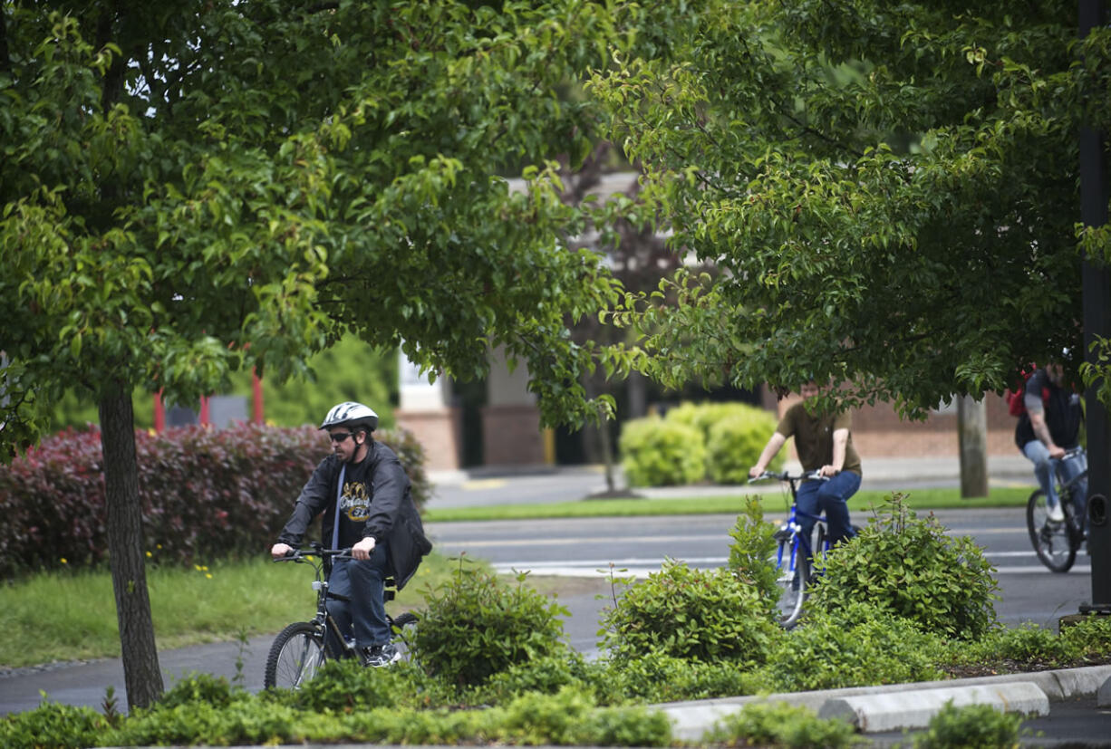 Rick Larson, 47, left, arrives at Vancouver's Human Services Council building after a group bike ride, part of safety training for participants in the Bike to Work Project.