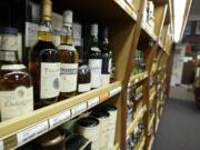 Bottles of scotch sit on a shelf at a state liquor store in Tumwater.