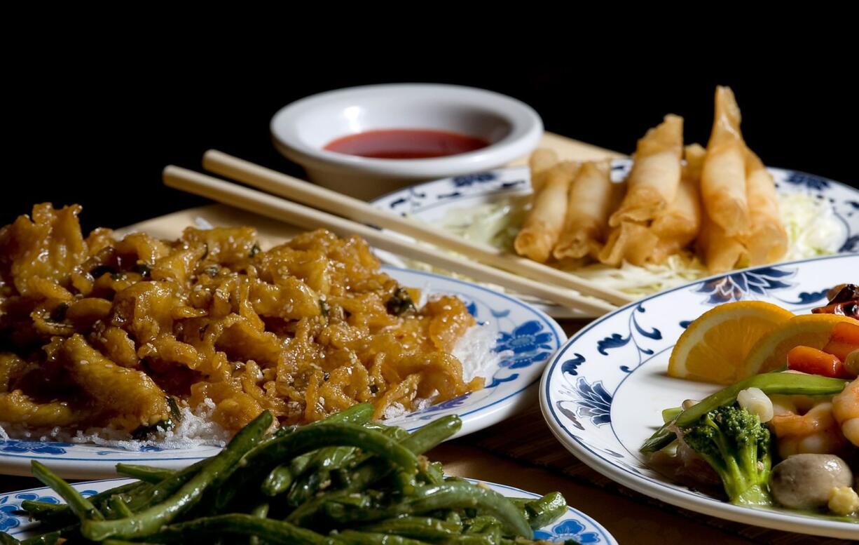 The Crispy Shrimp Rolls (clockwise from top), Dragon and Phoenix, Sauteed String Beans and Sesame Chicken were memorable dishes at the Golden City.