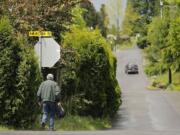 Bob Ellingwood, a member of a McCann Road volunteer traffic committee, walks near the intersection at 43rd Avenue and McCann Road.