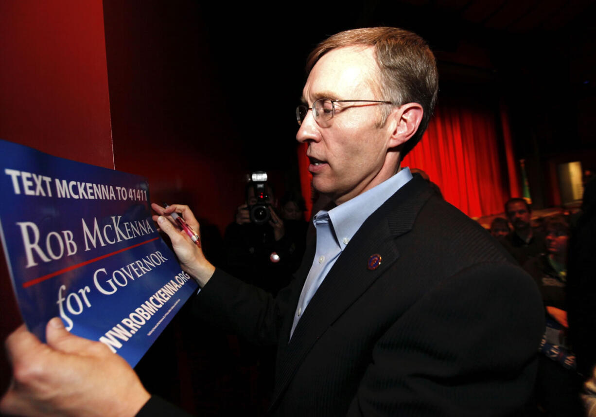 State Attorney General Rob McKenna autographs a campaign sign after addressing supporters at Sammamish High School Wednesday in Bellevue. McKenna announced that he will be running for governor for the 2012 election.
