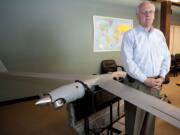 Steve Morrow, president and CEO of Insitu Inc., with a model of the company's ScanEagle unmanned aircraft.