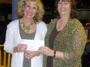 Nancy Miller, left, executive director of the Rocksolid Teen Center, accepts grant money from Anne Digenis, grants officer at The Community Foundation.