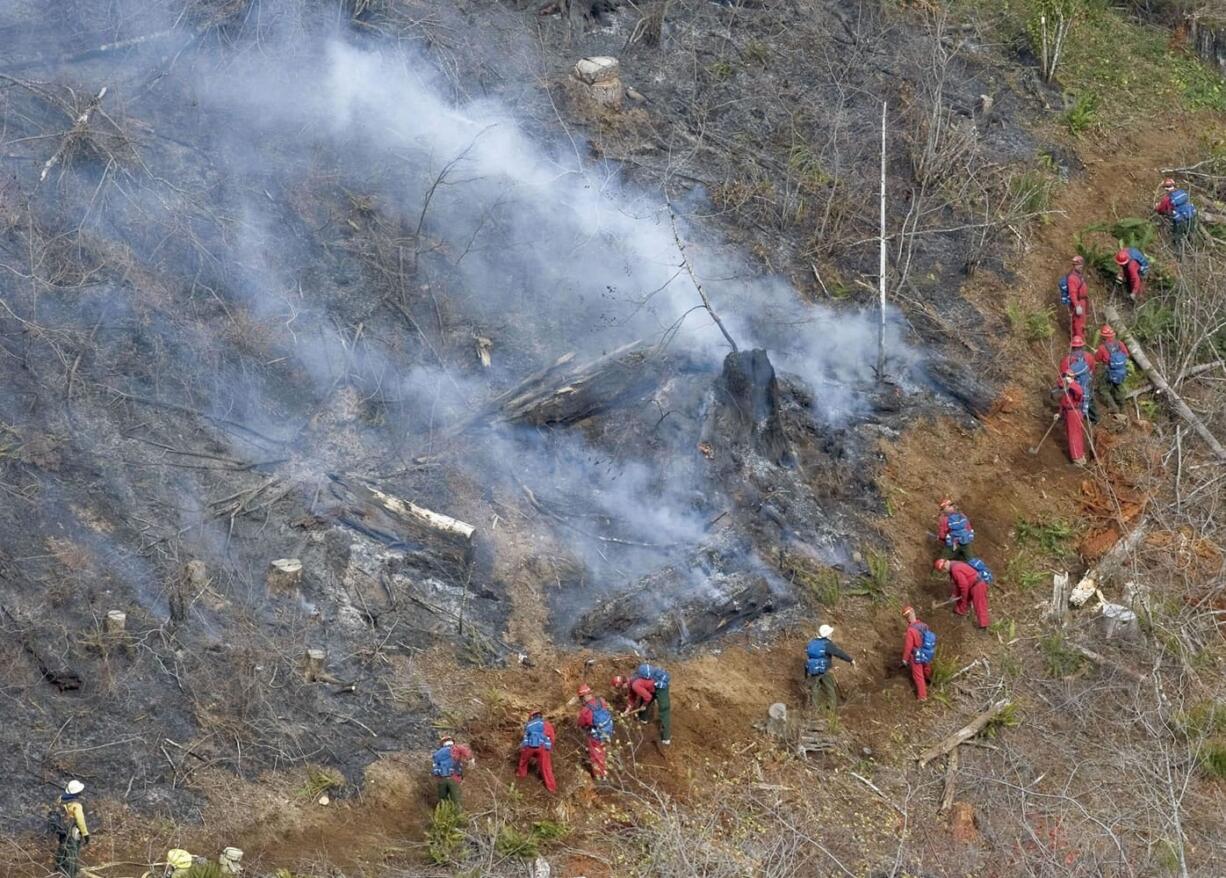 Honor crews from Larch Correctional Facility tend to a 40-50 acre fire burning in the Yacolt Burn State Forest near Washougal on October 12, 2009.