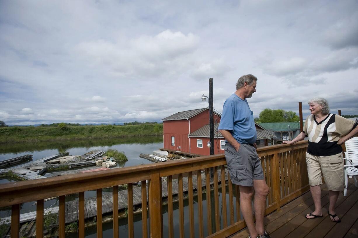 Larry and Penny Rasmussen enjoy the view from the top deck of their floating home which they rent at Mc Cuddy's Marina in Ridgefield.