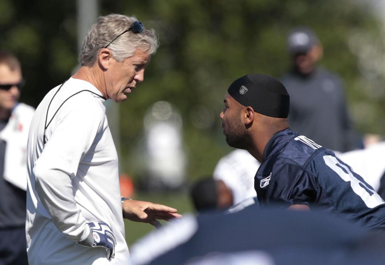 Seattle Seahawks head coach Pete Carroll, left, talks with Golden Tate at a walkthrough football practice Thursday in Renton.